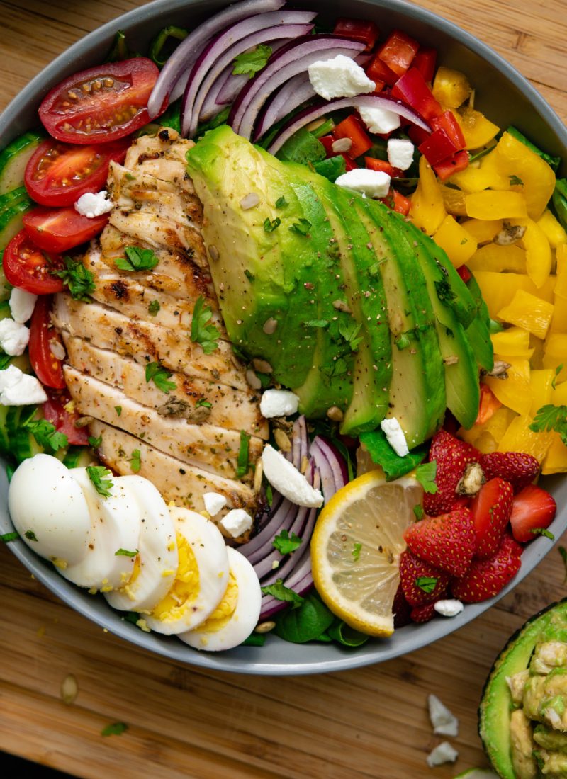 Chicken salad with boiled egg red onion avocado and tomatoes.