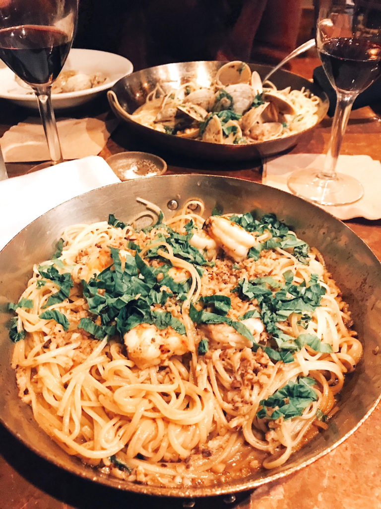 Seafood pasta dishes at Street & Co, with red wine in Portland Maine